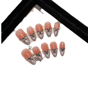 Pink gradient press-on nails with silver glitter and rhinestone bow decoration