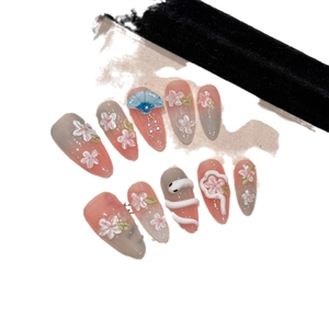 Handmade press-on nails featuring 3D peach blossom relief and Japanese art style details