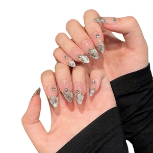 Handmade leopard print stiletto press-on nails with silver glitter and 3D rhinestones