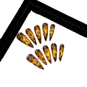Handmade amber cat-eye stiletto press-on nails with black leopard print and glitter