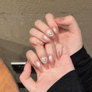 Pink cat eye handmade press-on nails with heart patterns and glitter in coffin shape