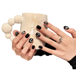 Short round black handmade press-on nails with glitter and cute cat paw patterns