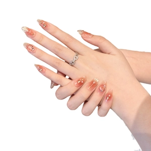 Handmade gradient orange press-on nails with pearls and crystals on long almond shape