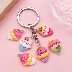 Cute strawberry ice cream cone resin keychains set with colorful charms on pink background