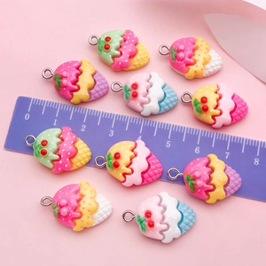 Flat lay of colorful resin ice cream and cherry charms with a ruler showing 2.2cm size