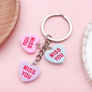 Resin heart charms keychain with Miss You lettering in pink, blue and purple tones