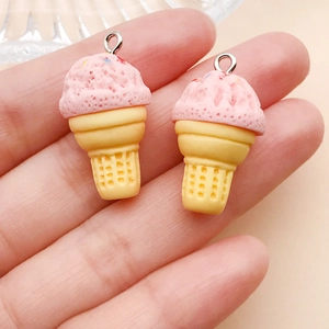Detail of resin ice cream cone charms held in hand showing size and pink color texture