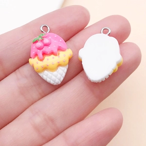 Detail of a DIY resin ice cream charm with pink cherry decoration and silver loop
