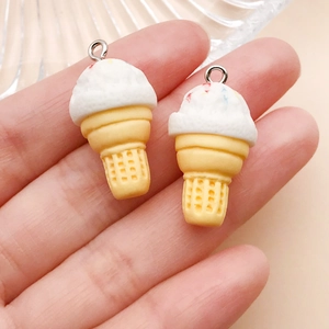 Macro detail of miniature resin colorful ice cream cone pendants with silver metal hooks