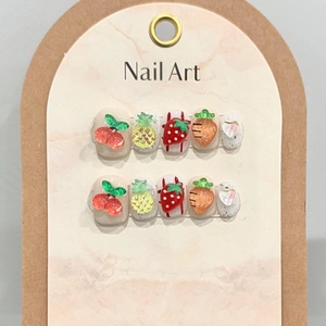 Handmade 3D fruit press-on nails with cherry and pineapple designs on pink marble