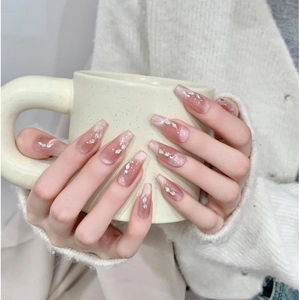 Pink gradient cat eye coffin press-on nails with rhinestones on a knitted background
