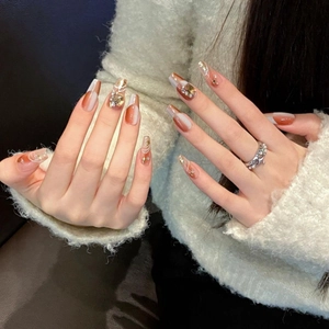 Elegant amber and white marble press-on nails with pearls on long coffin shape