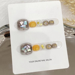 Handmade white and orange ocean style press-on toenails with shell and gold foil accents