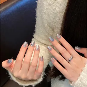 Handmade ice blue cat eye press-on nails decorated with silver glitter and rhinestones