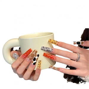 Extra long coffin press-on nails featuring various animal prints and abstract patterns