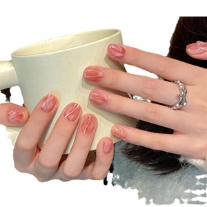 Short round press-on nails with amber marble texture and white line art detailing