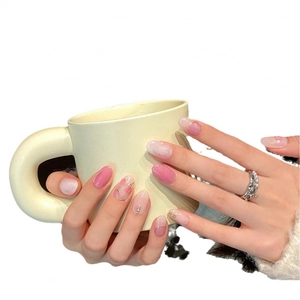 Pink gradient press-on nails with hand-painted tulip patterns and rhinestone accents