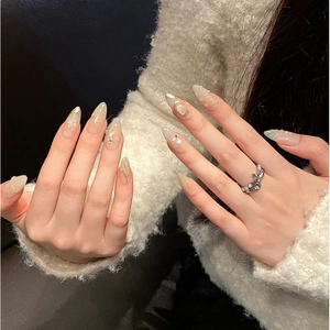 Handmade nude cat eye press-on nails with pearls and gold glitter in long almond shape