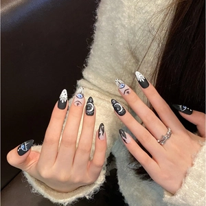 Handmade almond press-on nails with blue evil eye, moon, and star mystic art designs