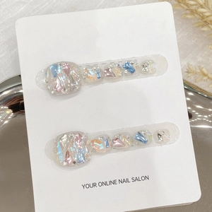 Handmade press-on toenails with iridescent shell and glitter flakes on display card