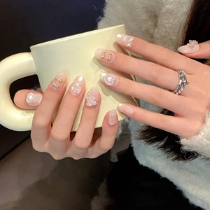 Elegante handgemachte Press-on-Nägel in Nudepink mit Aurora-Perlglanz und 3D-Schleife