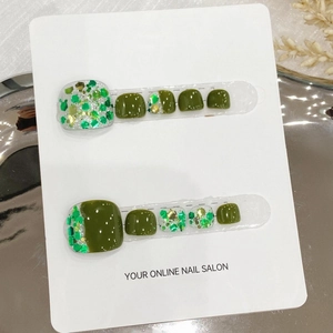 Olive green and glitter handmade press-on toe nails displayed on a white product card