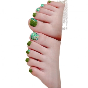 Handmade dark green and glitter square press-on toenails on a white background