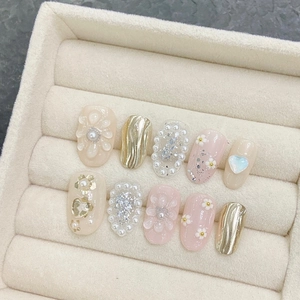 Handmade press-on nails featuring 3D gold foil flowers and pearls in soft pink and beige