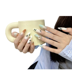 Handmade almond press-on nails with 3D white floral design and mint green gradient