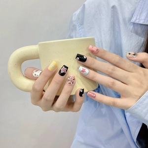 Handmade press-on nails with colorful stars and hearts design for a sweet summer look