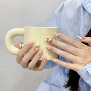 Handmade almond press-on nails with white floral hand-painted designs and aurora finish