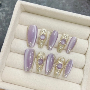 Handmade lavender cat-eye press-on nails with golden texture and purple gems
