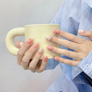 Pink blush press-on nails with 3D white flowers, silver glitter, and rhinestones