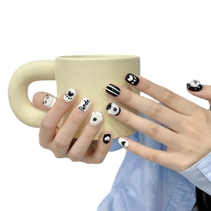 Handmade 3D panda press-on nails with black and white stripes and cute heart designs