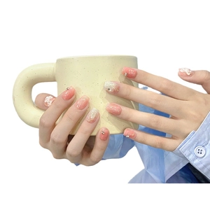Pink blush press-on nails with 3D white flowers and glitter on soft peach gradient