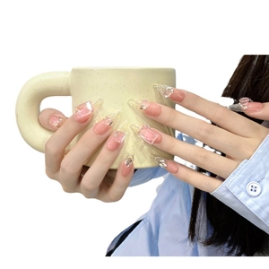 Pink translucent press-on nails with 3D crystal cubes, pearls and bows in almond shape