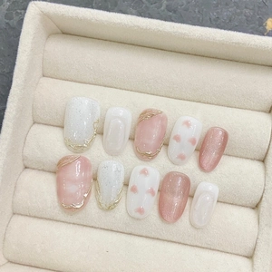 Handmade press-on nails with pink heart patterns and shimmering silver glitter