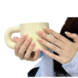 Pink French press-on nails with hand-painted tulips and pearls in a medium square shape