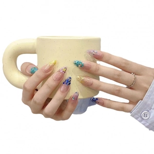 Sparkly mermaid gradient press-on nails with blue glitter and sequins on long almond shape