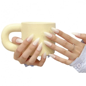Handmade pearlescent white almond-shaped press-on nails shown on a hand with glossy finish