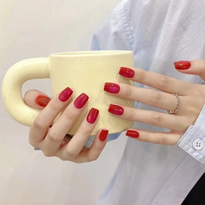 Handmade burgundy cat-eye press-on nails with glossy finish on short square-oval shape