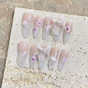 Handmade press-on nails with luxury butterfly and swan 3D charms in pink gradient