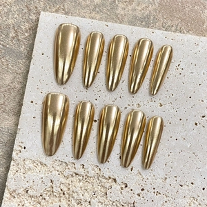 Handmade champagne gold mirror finish press-on nails with long pointed stiletto shape
