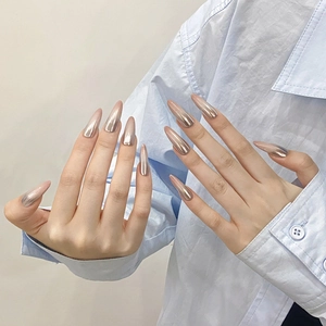 Handmade press-on nails with champagne gold chrome mirror finish in long stiletto shape