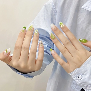 Handmade light green coffin press-on nails with cute hand-painted monster and leaf designs