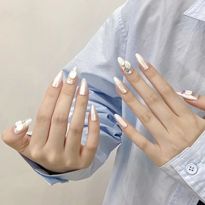 Luxury handmade almond press-on nails with pearlescent finish and 3D crystal accents