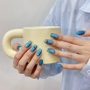 Blue cat eye press-on nails featuring 3D goldfish decor and clear water drop accents