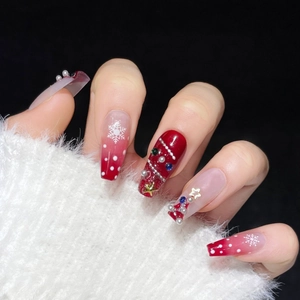 Handmade Christmas press-on nails with red gradient, white snowflakes and 3D tree charms