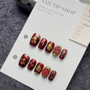 Press-on nail set in deep burgundy with gold foil, pearls, and Chinese New Year motifs