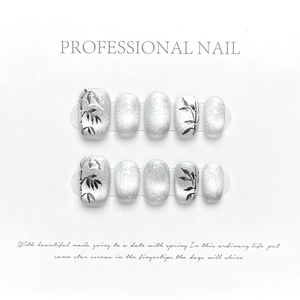 Silver cat eye press-on nails with black ink bamboo design in short square shape